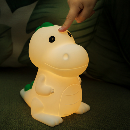 Hand showing touch feature for adjusting brightness level for the dinosaur night light.