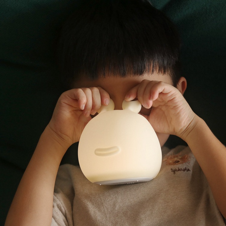 Child holding the slug night light.