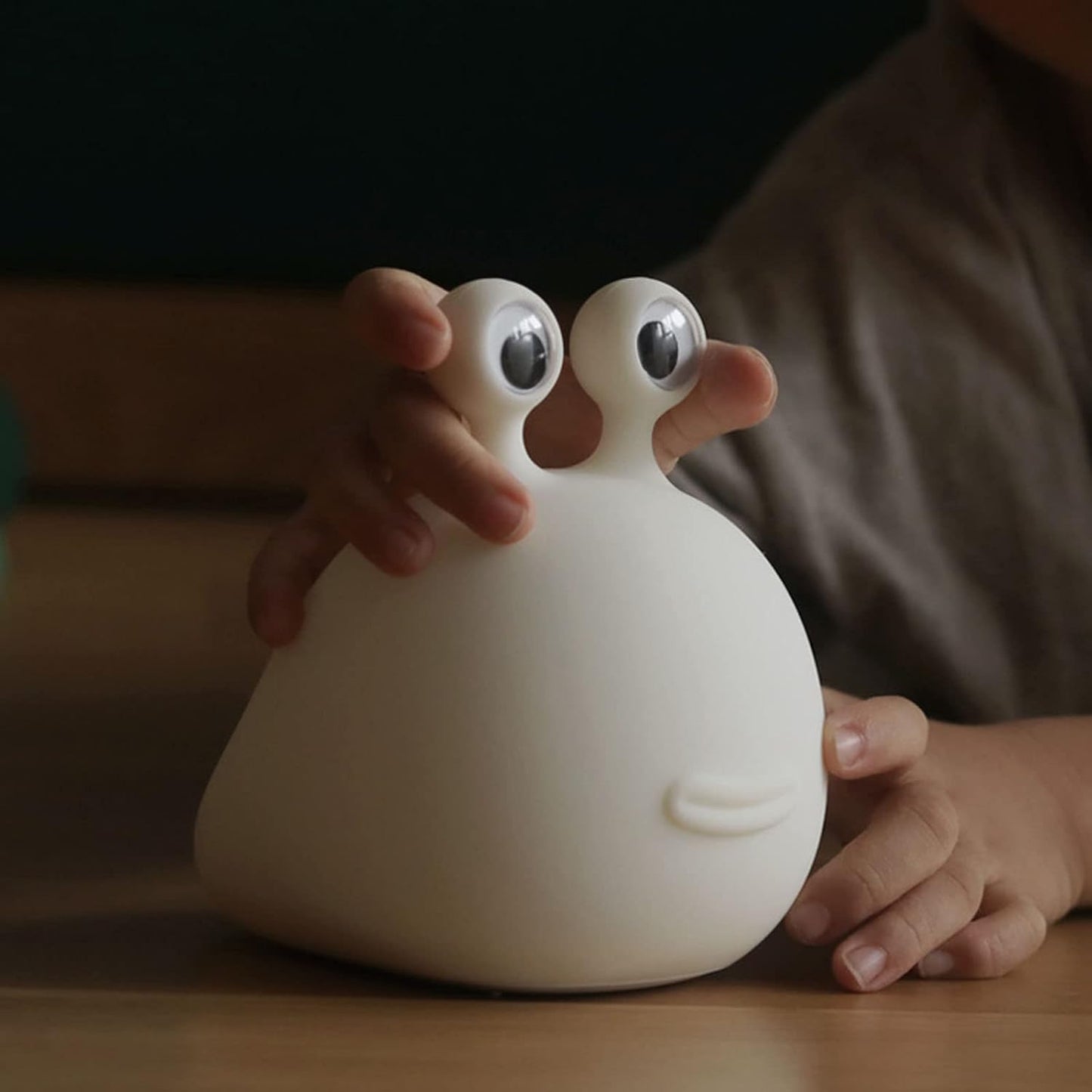 Child playing with the slug night light.