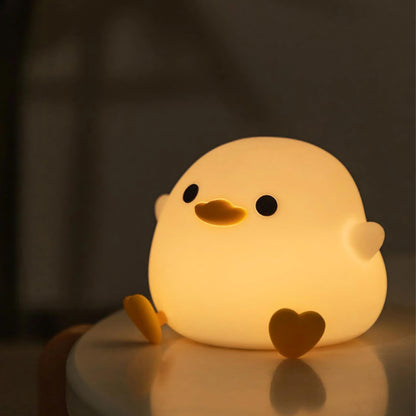 Duck night light providing a soft glow and illuminating a dark room.