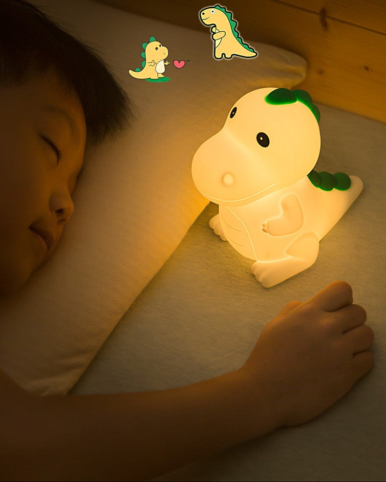 Child sleeping peacefully next to the soothing warm glow of the night light in their bed.